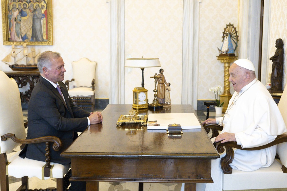 Pope and King sit across from each other at Pope's desk