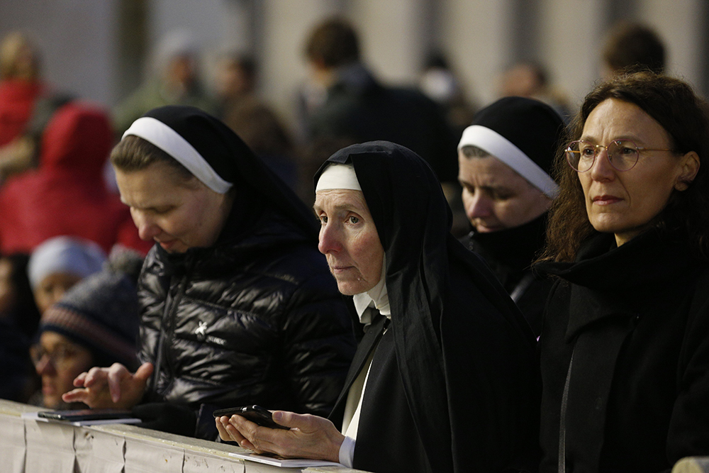 Women religious pray in St. Peter's Square at the Vatican before Pope Francis' celebration of the funeral Mass of Pope Benedict XVI on Jan. 5. (CNS/Paul Haring)