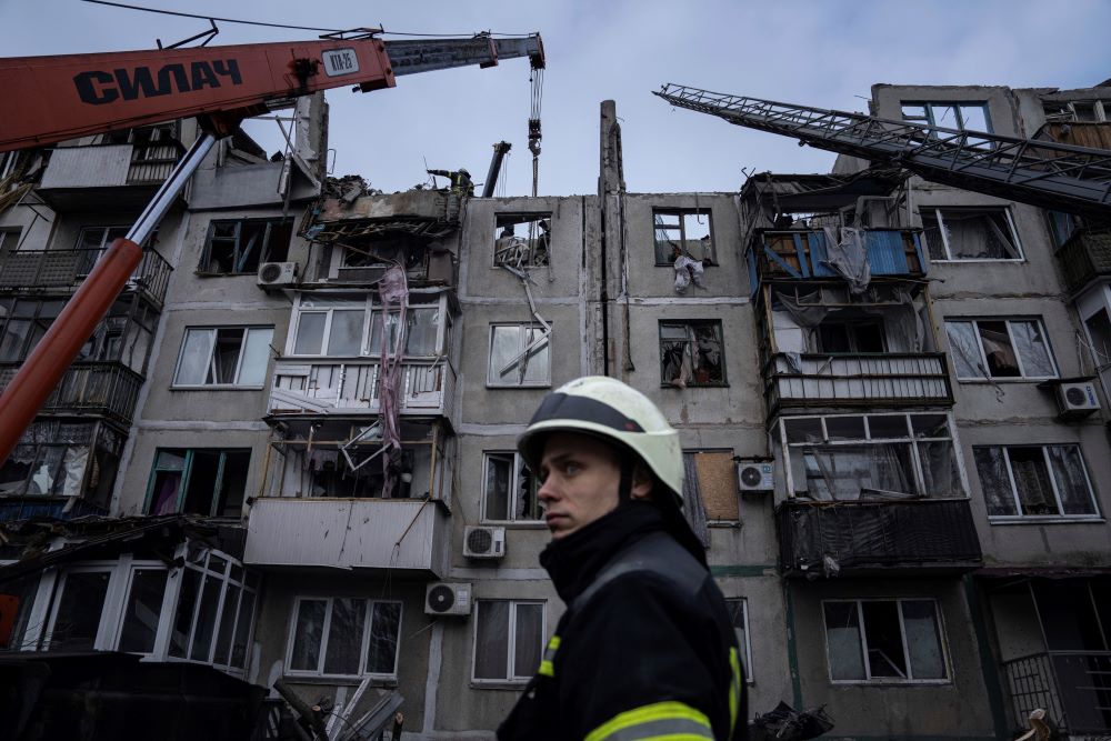 Rescue workers clear the rubble of a residential building Feb. 15 that a Russian rocket destroyed in Pokrovsk, Ukraine. (AP Photo/Evgeniy Maloletka)