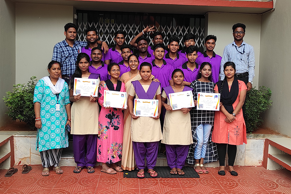 Sr. Remya Thomas, tan sari with glasses, poses with St. Joseph Community College students holding their certificates showing they have successfully completed their courses. (Courtesy of Remya Thomas)