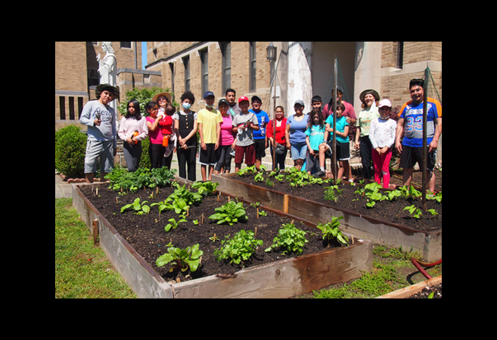 The Care of Creation Ministry of St. John the Evangelist and Our Lady of Mount Carmel Parish in White Plains, New York, works with children and their parents to plant vegetables and herbs in four raised beds on the church's grounds. The produce is then donated to a local food pantry. Sr. Maco Cassetta is third from the right. (Courtesy of Maco Cassetta)