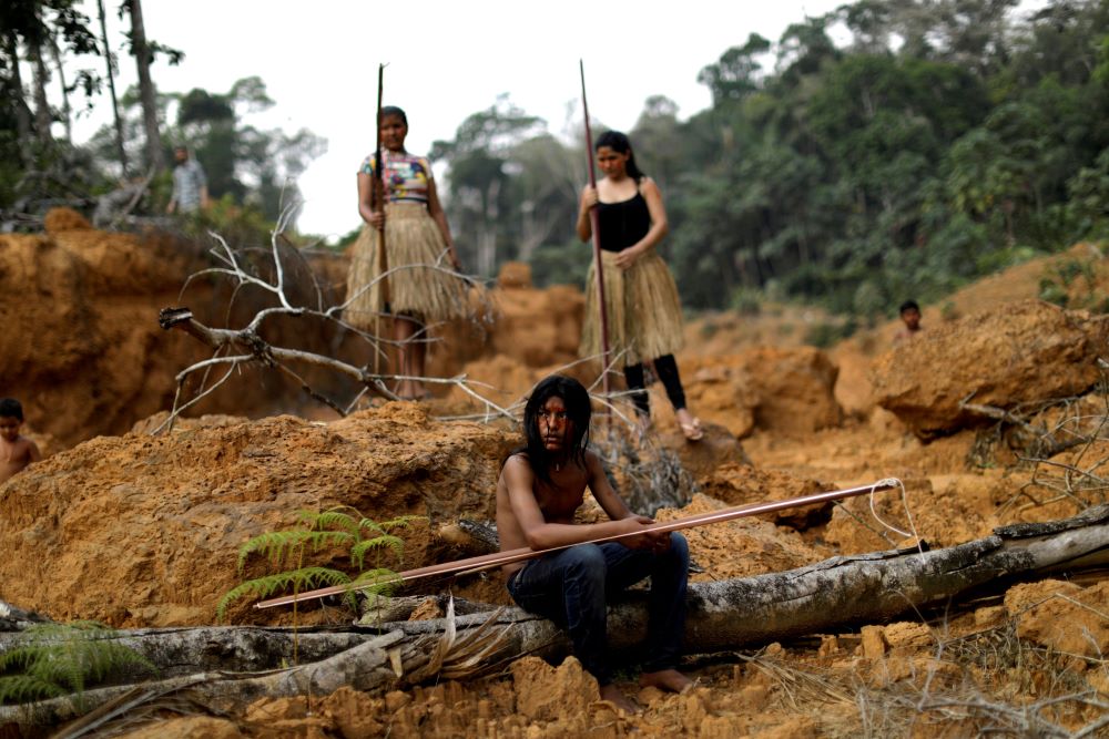 Young people from the Mura tribe are pictured in a file photo at a deforested area on unmarked Indigenous lands inside the Amazon rainforest near Humaita, Brazil. (CNS/Reuters/Ueslei Marcelino) The possibility of escalating violence