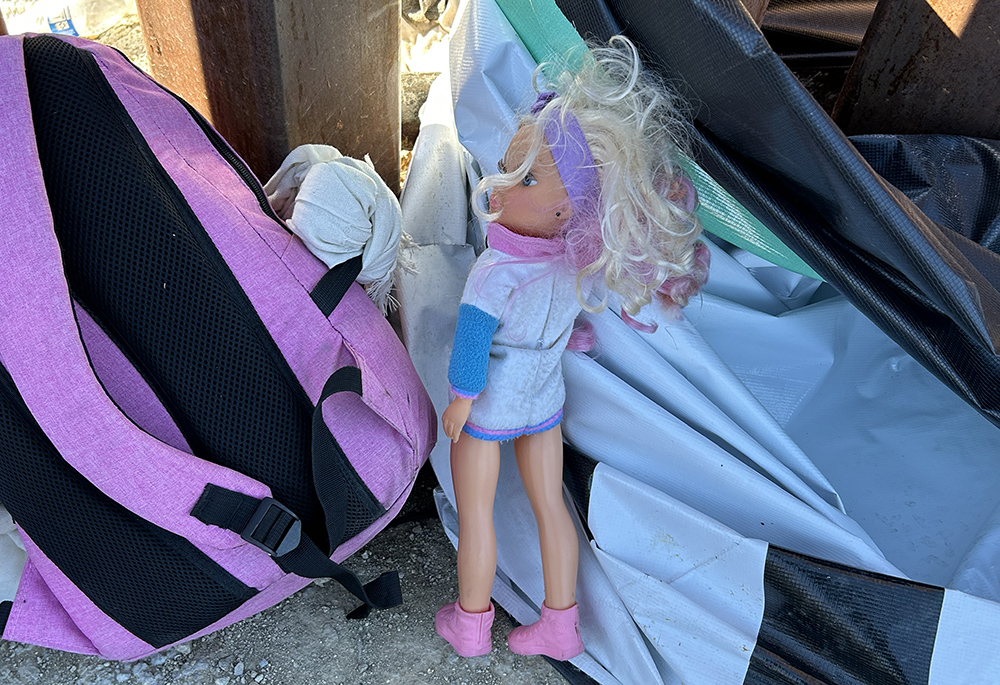 A doll is pictured, belonging to a child who had just entered the U.S. with her family through a gap in the border wall. The child, her sibling and their mother sat down on an empty milk crate. They set their few belongings aside, including the doll. (Peter Tran) 