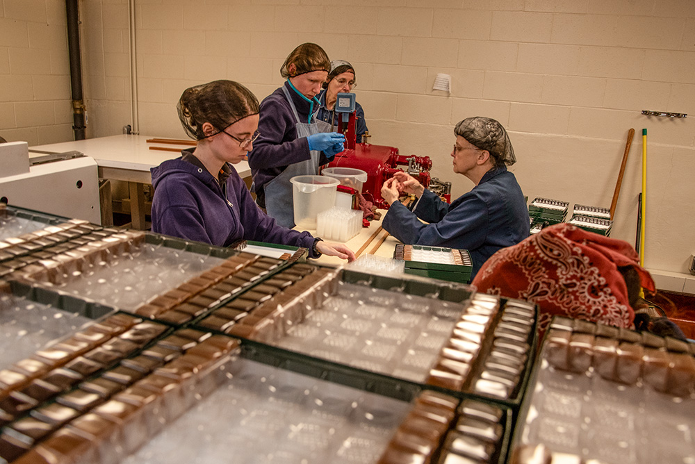 Wrapped caramels wait on shelves to complete the boxing process for Monastery Candy, the company run by the Trappistine nuns at Our Lady of the Mississippi Abbey near Dubuque, Iowa. (Courtesy of Bill Witt)