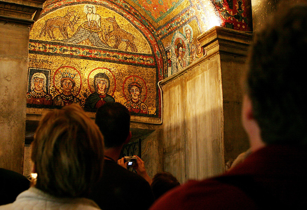 A group of women on a pilgrimage sponsored by FutureChurch views a ninth-century mosaic in Rome's St. Praxedis Church, in this 2006 file photo. The mosaic shows the Blessed Virgin Mary, Sts. Praxedis and Pudentia, and a woman, Theodora, who has the word "Episcopa" inscribed above her. FutureChurch advocates the ordination of women priests and dispensing with the celibacy requirement for priests. (CNS/Carrie Leonard)