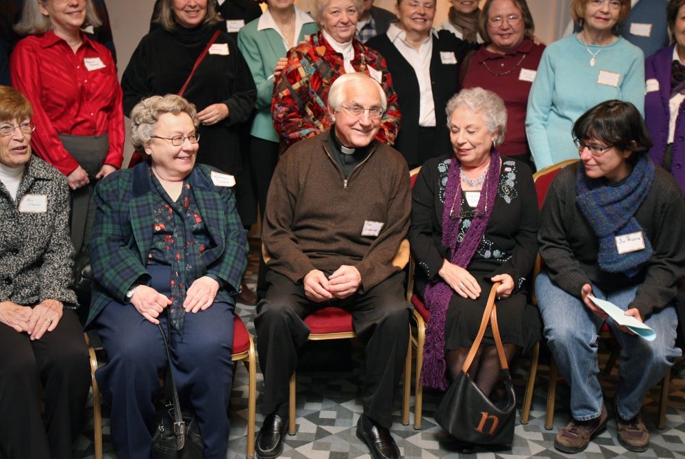 Bishop Thomas Gumbleton poses for a photo with a group of women during a Voice of the Faithful gathering in Washington Feb. 24, 2007. 