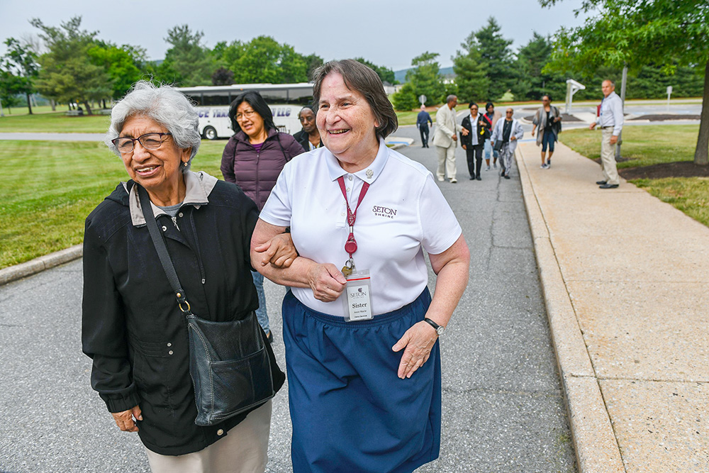 Daughter of Charity Sr. Anne Marie Lamoureux, right, welcomes guests at the National Shrine of St. Elizabeth Ann Seton in Emmitsburg, Maryland. A dream of Lamoureux’s grew into Seeds of Hope, a program that offers retreats to those marginalized by society. (Courtesy of the National Shrine of St. Elizabeth Ann Seton)