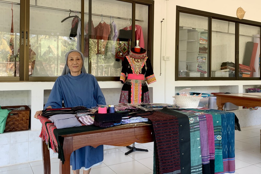 Sr. Manivong Phasangkhonesy shows some of the fine clothes made in the Nazareth Center's sewing shop. (Akarath Soukhaphon)