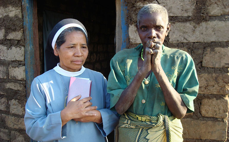 Sr. Liesbeth Runes and Mama Rosalia pray during the blessing of Mama Rosalia’s new house. (Maureen Sinnott)