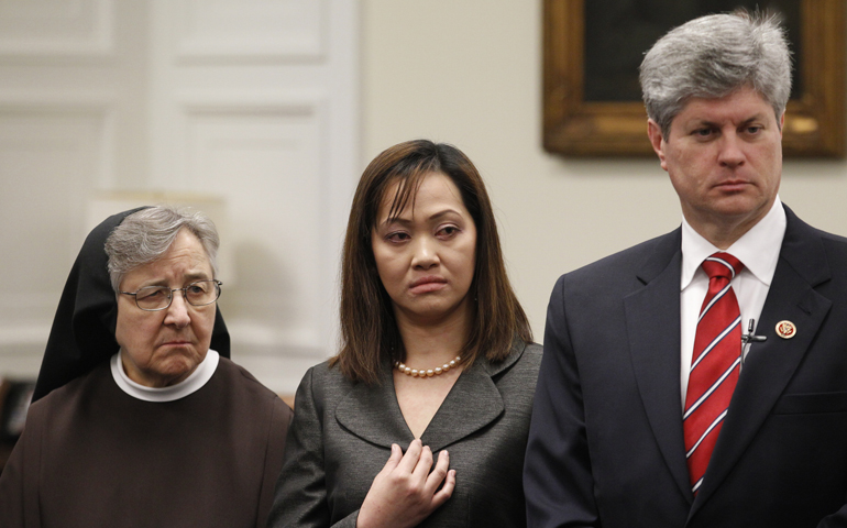 Franciscan Sr. Jane Marie Klein, who chairs the board of Franciscan Alliance, registered nurse Cathy Cenzon-DeCarlo and U.S. Rep. Jeff Fortenberry, R-Neb., listens to a speaker during a Tuesday press conference on Capitol Hill in Washington. (CNS/Bob Roller) 