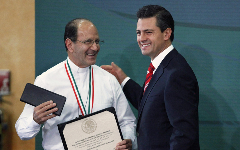 Fr. Alejandro Solalinde is congratulated by Mexico's President Enrique Pena Nieto after being awarded the National Human Rights Award on Monday at the presidential palace on International Human Rights Day in Mexico City. (CNS/Reuters/Edgard Garrido)