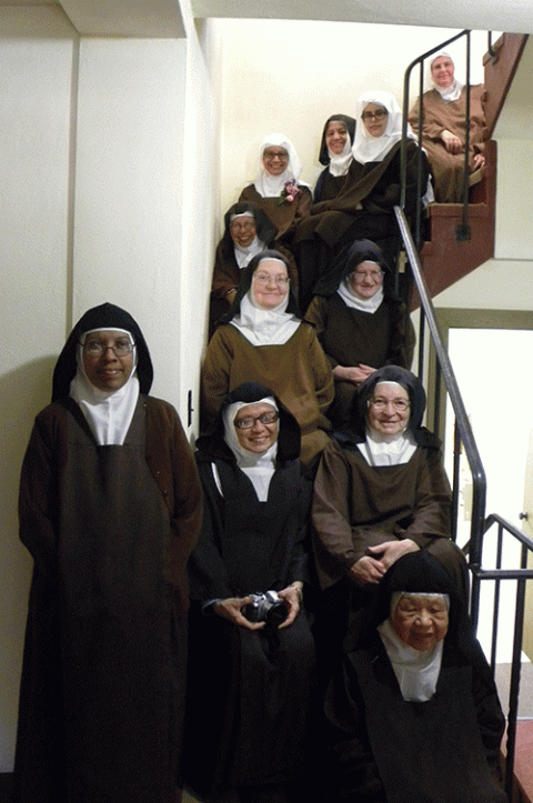 The Discalced Carmelites of Carmel, California, seen on the stairs of their monastery (Provided photo)