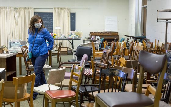 A woman in Farmington Hills, Michigan, browses items March 19 at the estate sale held by the Sisters of Mercy as they clean out their former convent. (CNS/Jim West)