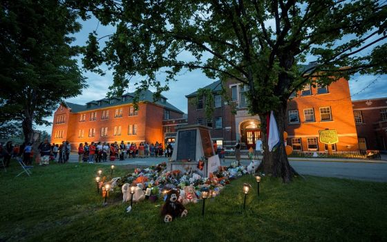 Kamloops residents and First Nations people gather to listen to drummers and singers at a May 31 memorial in front of the former Kamloops Indian Residential School in British Columbia. (CNS/Reuters/Dennis Owen)