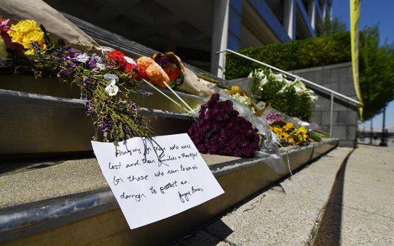 Flowers and a message of hope sit on the steps of the Old National Bank in Louisville, Kentucky, on April 11.