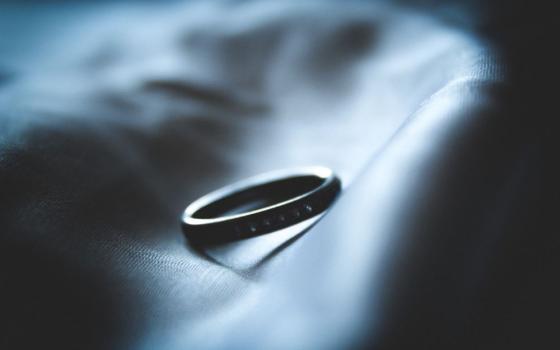 closeup of a hand holding a ring 
