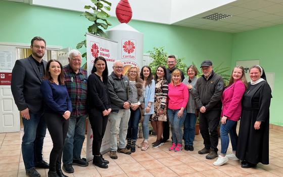 Poland Caritas staff and psychologists in Rzeszow, Poland, are pictured with visitors from the U.S., including Jim McDermott, former U.S. representative, third from the left; NCR contributor Fr. Peter Daly, fifth from the left; and NCR board member David Bonior, also a former U.S. representative, third from the right. (Courtesy of David Bonior)