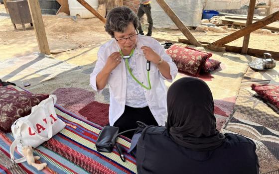 Sr. Julia Hurtado nurses an elderly bedouin at El Montar Bedouin Camp in the Judean Desert.