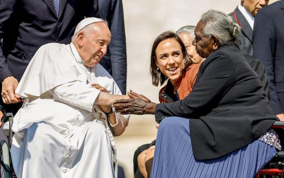 Pope Francis greets Miriam-Rose Ungunmerr Baumann, an Australian Aboriginal elder, educator and artist, after his weekly general audience May 31, 2023, in St. Peter's Square at the Vatican. Looking on is Chiara Porro, Australian ambassador to the Holy See. (CNS/Lola Gomez)
