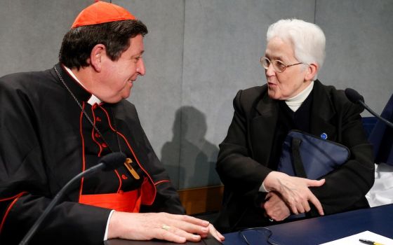Brazilian Cardinal João Bráz de Aviz speaks with Immaculate Heart of Mary Sr. Sharon Holland, then president of the Leadership Conference of Women Religious, at the conclusion of a Dec. 16, 2014, Vatican press conference on the release of the final report