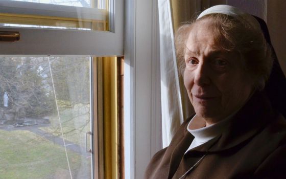 Sr. Marcia Kay LaCour, abbess of the Poor Clares in Spokane, Washington, at a window overlooking the grounds of the Monastery of St. Clare on Jan. 30 (GSR photo / Dan Stockman)