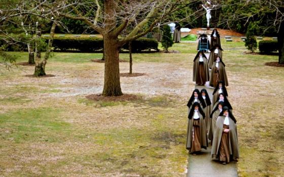Poor Clare Colettine nuns walk back to the monastery after a funeral service, in 2010, for a cloistered nun who served in WWII before she joined an active order of nuns, and then transferred to the cloistered order at the Corpus Christi Monastery in Rockford, Ill. (© Abbie Reese)