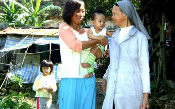 Sr. Ephrem Nguyen Thi Luu, a St. Paul de Chartres nun, visits a woman who has been a domestic violence victim. (GSR/Peter Nguyen)