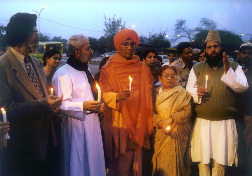People stand at an interfaith peace gathering in New Delhi in this undated photo. 