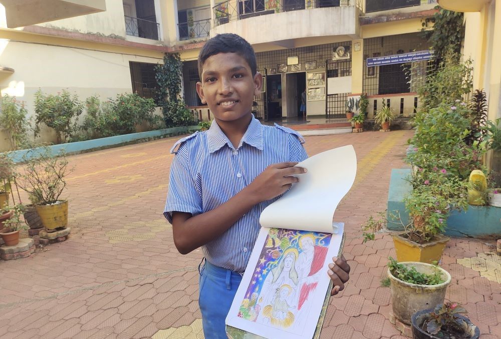 Prasad James, a ninth grader at Asha Niketan, shows his painting. 