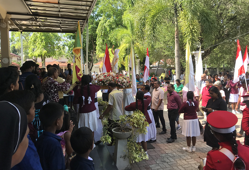 The Easter procession by the family members and parishioners with the statue of the risen Christ ends at St. Sebastian's Church, Katuwapitiya, Sri Lanka, March 31. (Thomas Scaria)