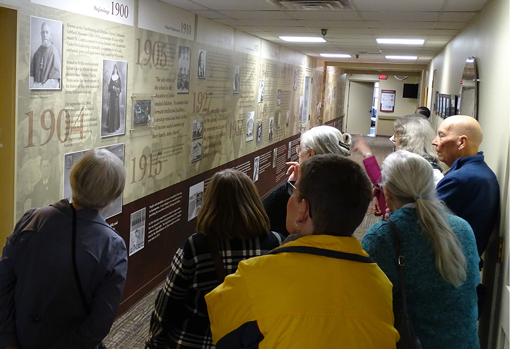FSPA pilgrims taking in a historical timeline at St. Coletta of Wisconsin, the first ministerial site for the sisters who traveled to Jefferson, Wisconsin, from Bavaria. (Courtesy of Franciscan Sisters of Perpetual Adoration)