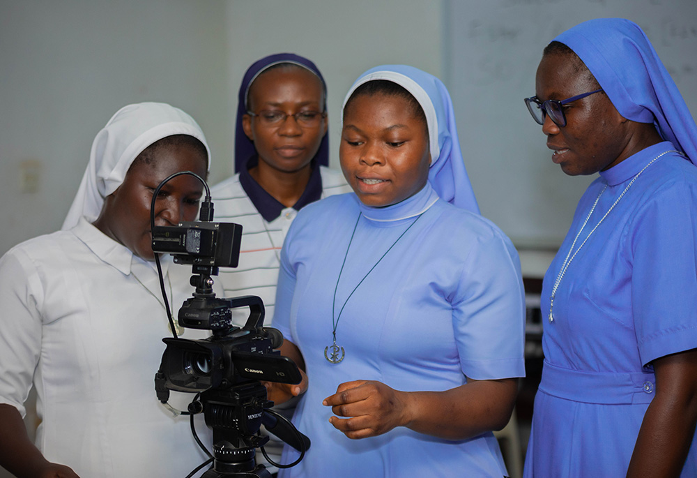 Sr. Francisca Yaa Konadu of the Society of the Infant Jesus, Sr. Sylvie Lum Cho of the Missionary Sisters of the Holy Rosary, Sr. Rebecca Asante of the Sisters of the Incarnate Word and Sr. Gifty Anastasia Blewu of the Sisters of Mary Mother of the Church practice with a video camera at a training session for sister communicators on May 9. (Newswatchgh.com/Damian Avevor)