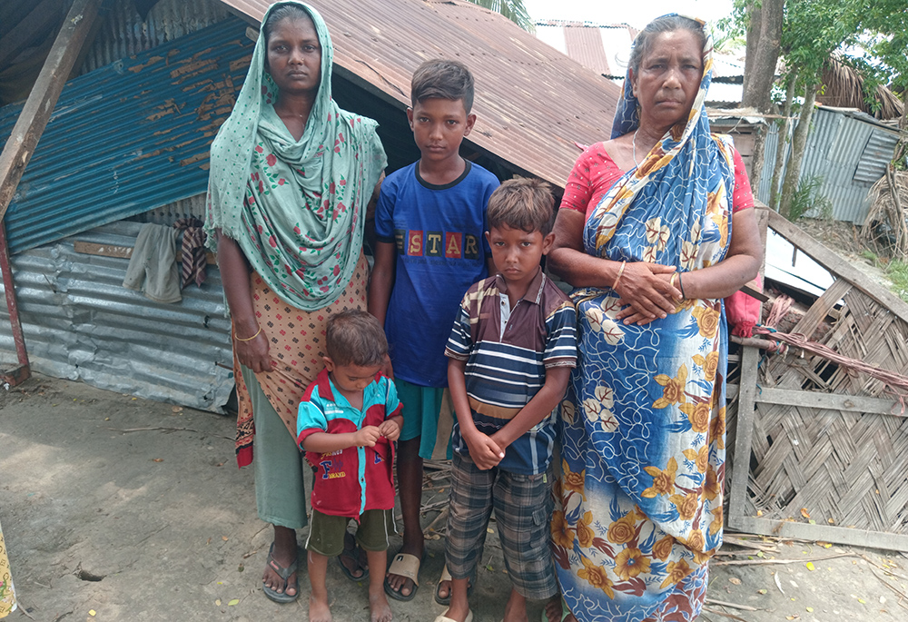 Sathi Sarder, 35, is pictured with her three sons and mother-in-law. Their house was damaged in the storm. They also couldn't repair it fully; as a result, they cannot install fans and endure heatwaves. (GSR photo/Sumon Corraya)