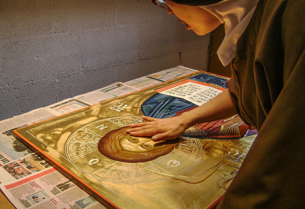 Benedictine Sr. Agnes Valderrama varnishes an icon with linseed oil, the last step in writing an icon, at the Abbey of Sainte-Marie des Deux-Montagnes in Sainte-Marthe-sur-le-Lac, Quebec. (Courtesy of Abbey of Sainte-Marie des Deux-Montagnes)