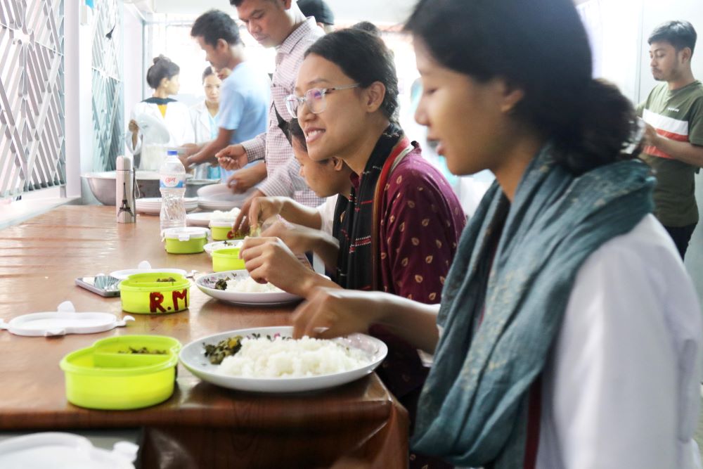Students of the Salesian Sisters' Nursing College eat lunch on the college's premises in Mymensingh, Bangladesh.