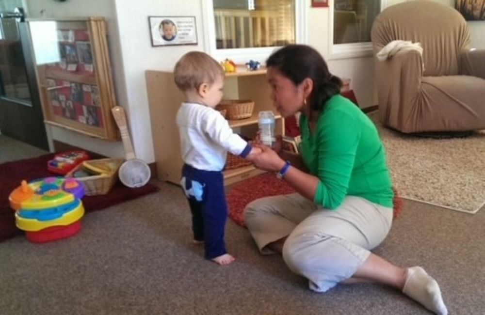 Sr. Nodelyn Abayan interacts wih a baby at a campus child care center in San Francisco in February 2014. She said she's grateful for the trust and sacred nature of working with babies and families.  (Courtesy of Nodelyn Abayan)