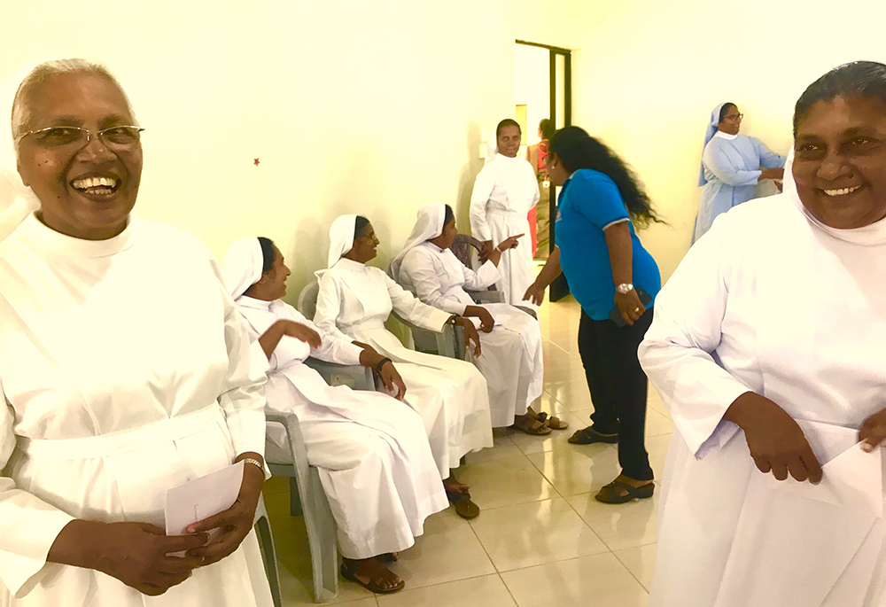Lay Salvatorian Ramani Seneviratne, in blue T-shirt, shares a lighter moment with the sisters during the final profession of two new Salvatorian sisters at the provincialate. Also pictured are Sr. Rani Fernando, left, and Sr. Shiroma Kurumbalapitiya, provincial. (Thomas Scaria)