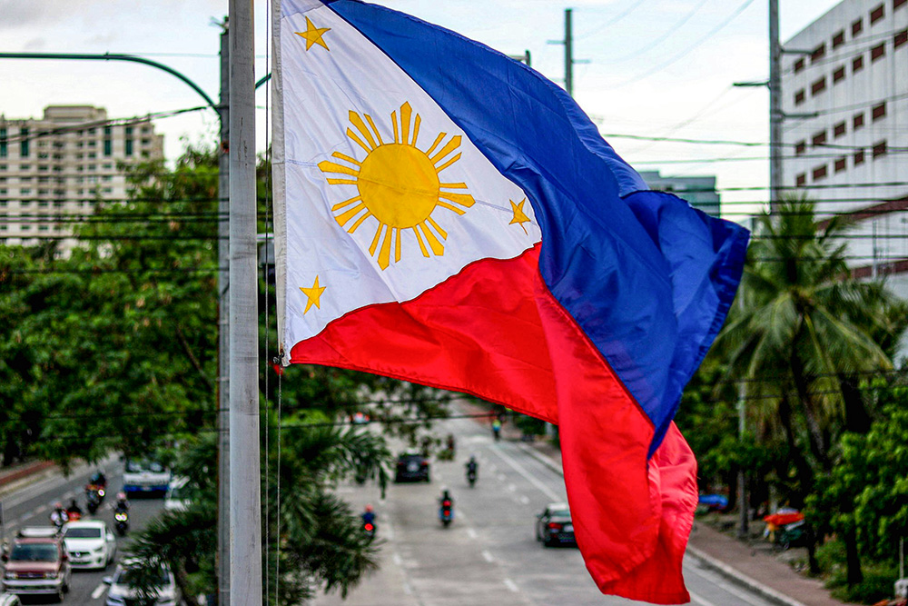 The national flag of the Philippines is seen flying in Manila. (Unsplash/iSawRed)