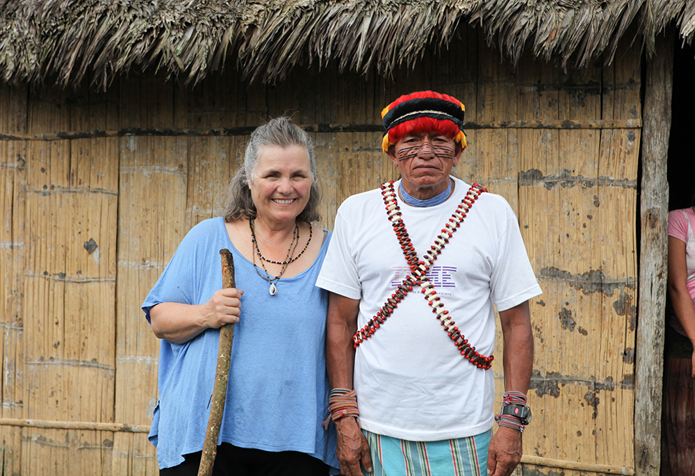 Sandra Morse, who co-founded Maketai with Sr. Judy Bisignano, stands beside an Achuar shaman. Morse said a trip to the Amazon she arranged for Bisignano sparked a deep interest in her friend for the region and its people. (Courtesy of Sandra Morse)
