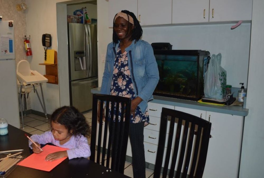 Franciscana Clarisa Sr. Stella Akello, intake officer at Bethany House of Hospitality for 18- to 25-year-old refugee women, spends time with residents' children after school is out May 7. 