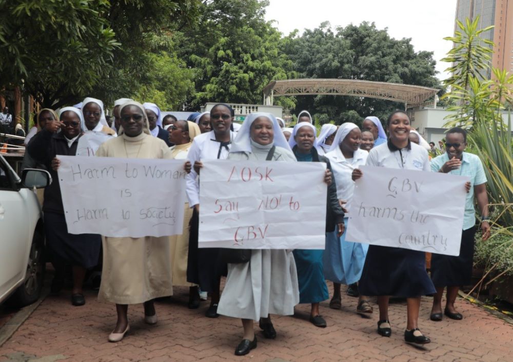 Members of the Association of Sisterhoods in Kenya carry signs to raise awareness about gender-based violence. 