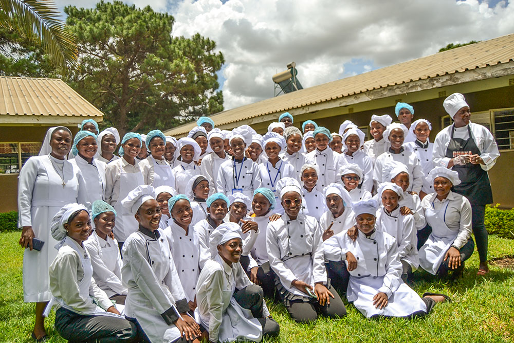 Salesian Sr. Margaret Mutale, left, poses for a photo with students of the Auxilium Skills Training Center in Makeni, Lusaka, Zambia. (GSR photo/Derrick Silimina)