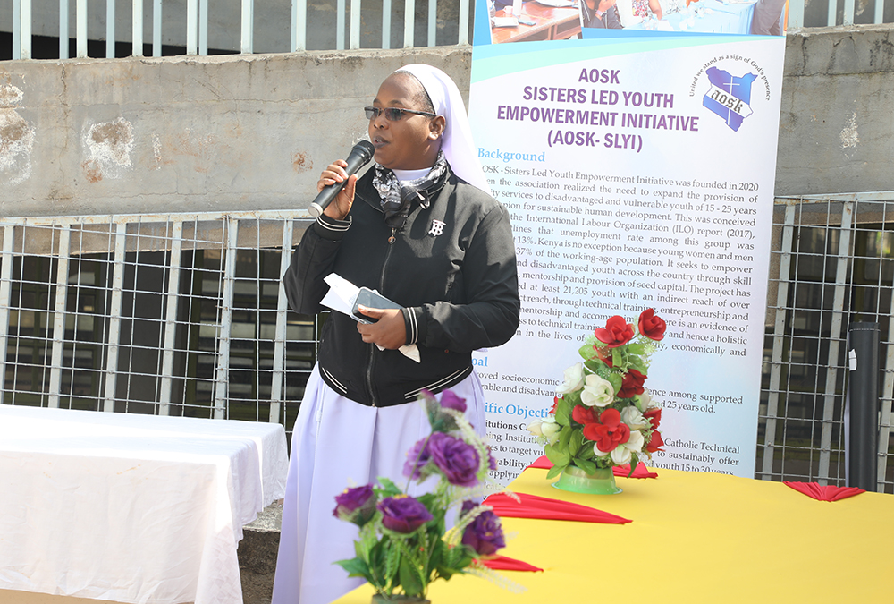 Sr. Mercy Mwayi, program manager of the Sisters' Led Youth Empowerment Initiative of the Association of Sisterhoods of Kenya, addresses a symposium of ministry officials, Catholic technical and vocational institutions, and hundreds of youth attendees who had gathered at St. Charles Lwanga Vocational Training Institute in Kibera, Nairobi, for the forum of the initiative's environmental conservation program. (Wycliff Peter Oundo)