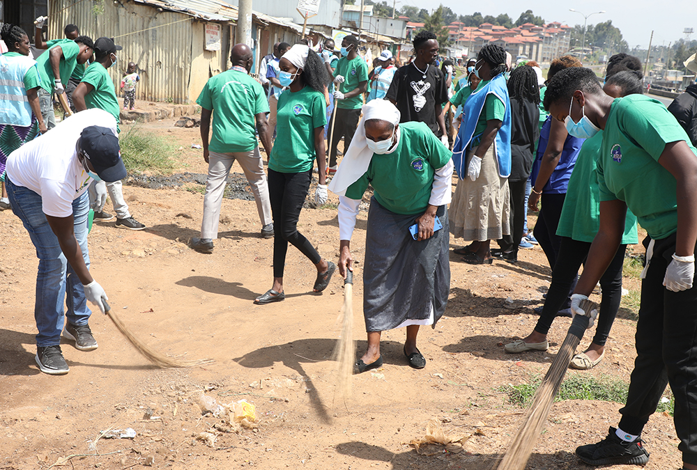 Sr. Celine Makario of the Sisters of Mary Kakamega leads a collective of youth from different technical training institutions in an environmental community service exercise that involved garbage collection, tree planting and cleaning efforts at the Raila Village in Nairobi’s largest slum, Kibera. (Wycliff Peter Oundo)