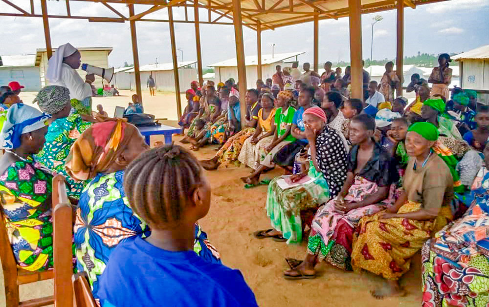 Servant of Jesus Sr. Angèle Gapio addresses refugees on the border of Uganda and the Democratic Republic of Congo. (Courtesy of Dieu Donne, Pax Christi International)