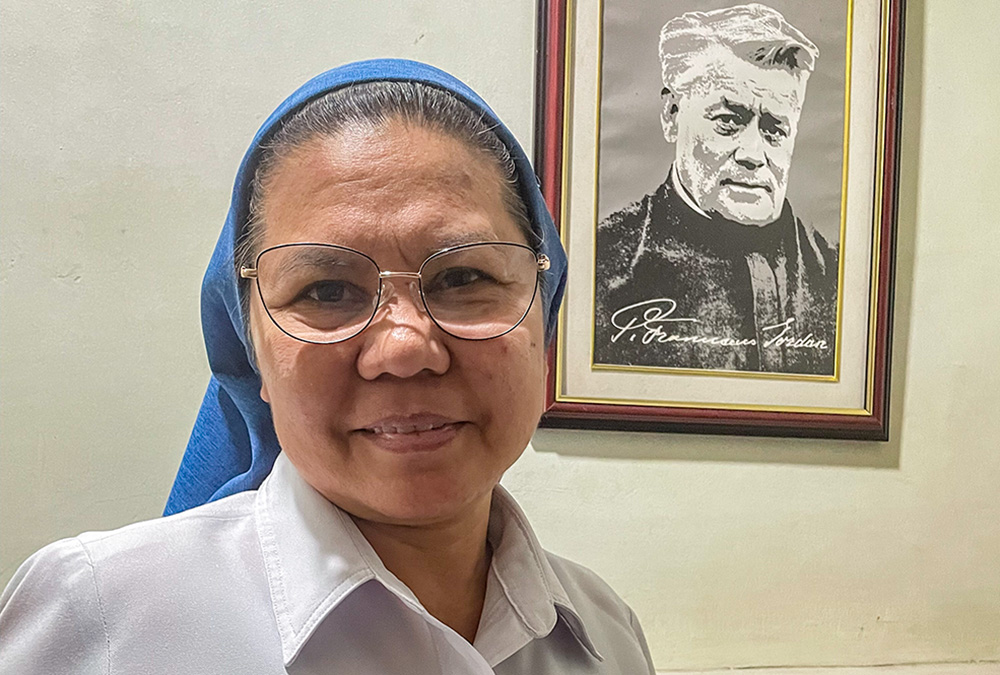 Salvatorian Sr. Mary Adeline Abamo poses next to a portrait of the founder of  the Society of the Divine Savior, Blessed Francis Mary of the Cross Jordan. (Tonette Orejas)