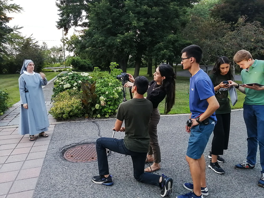 The youth of Mission Jeunesse in Montreal film Recluse Sr. Ginette Généreux and monitor the sound and light for the series "The Hidden Good in the City." (Courtesy of Mission Jeunesse)