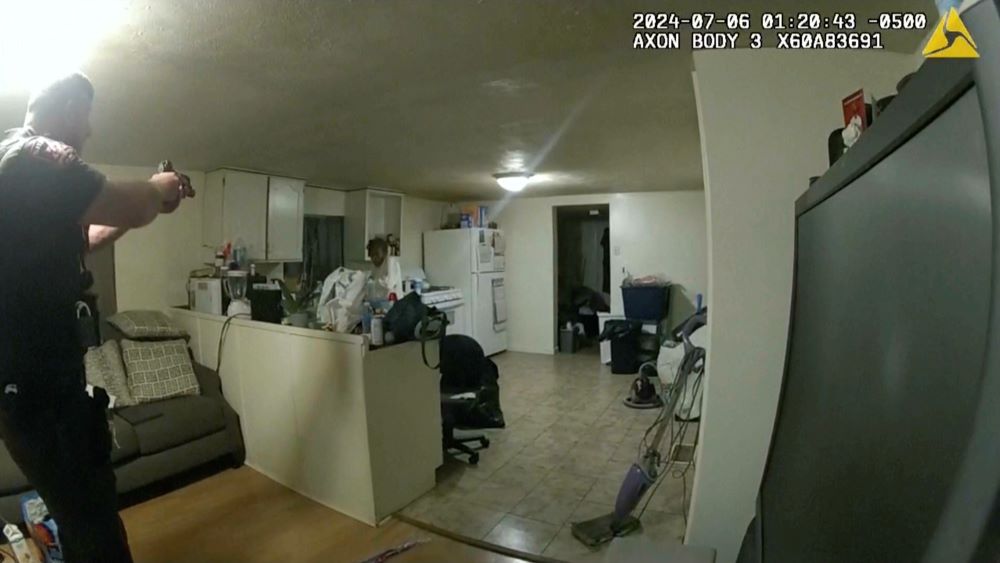 In this image taken from body camera video released by Illinois State Police on July 22, former Sangamon County Sheriff's Deputy Sean Grayson, left, points his gun at Sonya Massey, who called 911 for help, before shooting and killing her inside her home in Springfield, Ill., July 6. 