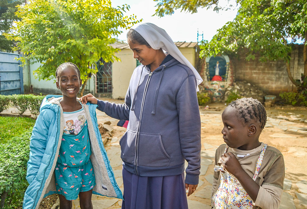 Immaculate Conception Sr. Theresa Kulandai engages the younger girls in conversation at Home of Joy, also known as Nyumba Yanga Orphanage, located on the grounds of the Marian Shrine in Lusaka, Zambia. (Derrick Silimina)