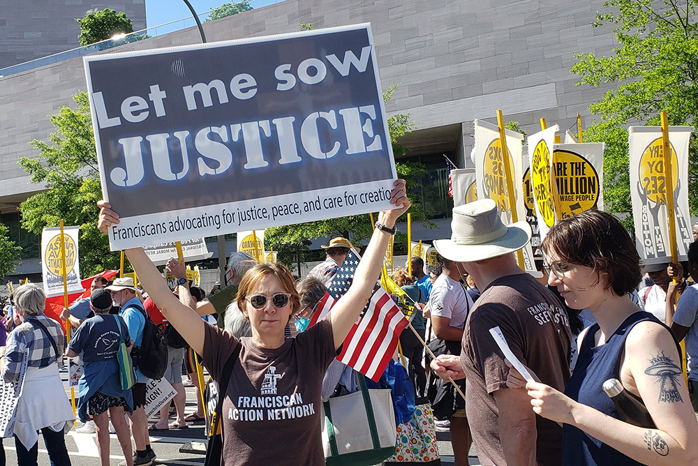 Members of Catholic groups take part in the Moral March on Washington June 18, 2022, sponsored by the Poor People's Campaign. The Catholic contingent was organized by Network, a Catholic social justice lobby; the Leadership Conference of Women; the Sisters of Mercy; Pax Christi USA; the Quixote Center; the Loretto Community; and the Franciscan Action Network. (CNS/Courtesy of Franciscan Action Network)